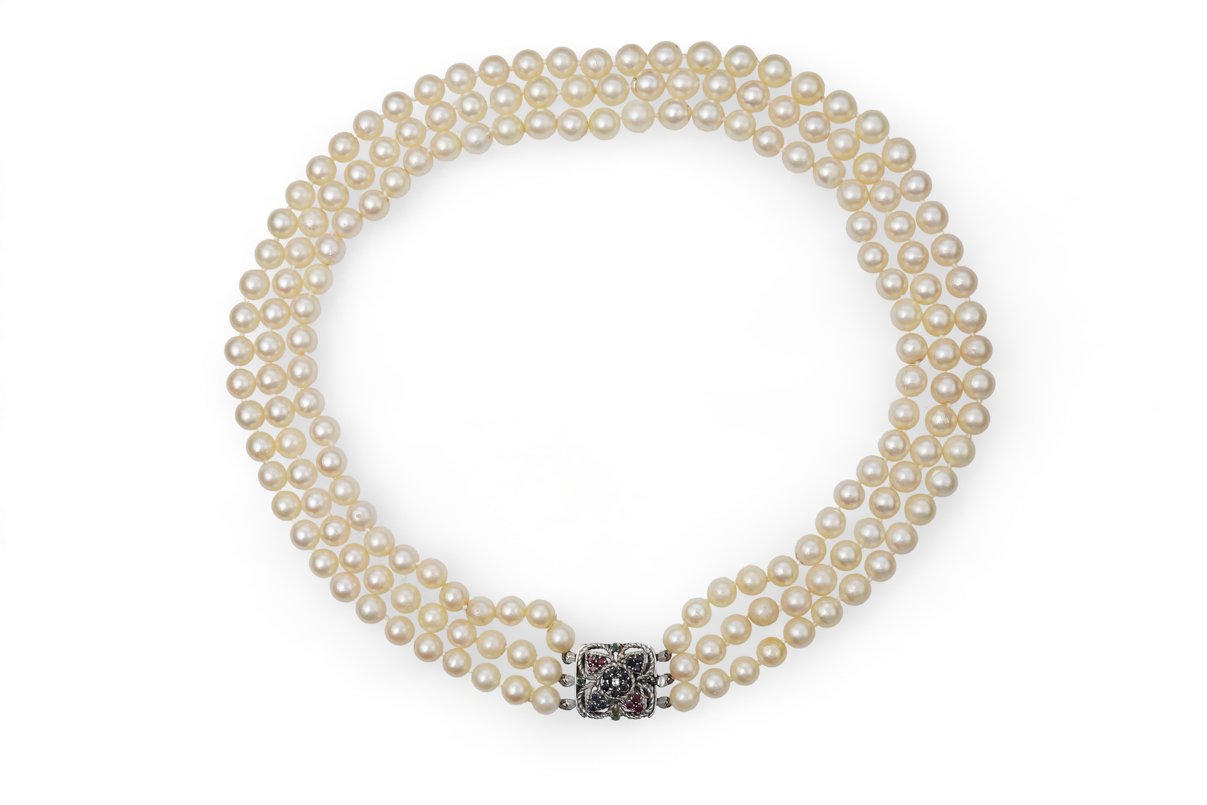 A mid to late 20th century Italian triple strand cultured pearl necklace, with emerald, sapphire and ruby cluster set 750 white metal clasp, 44cm.